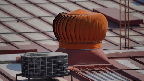 a roof ventilator on top of a building under construction
