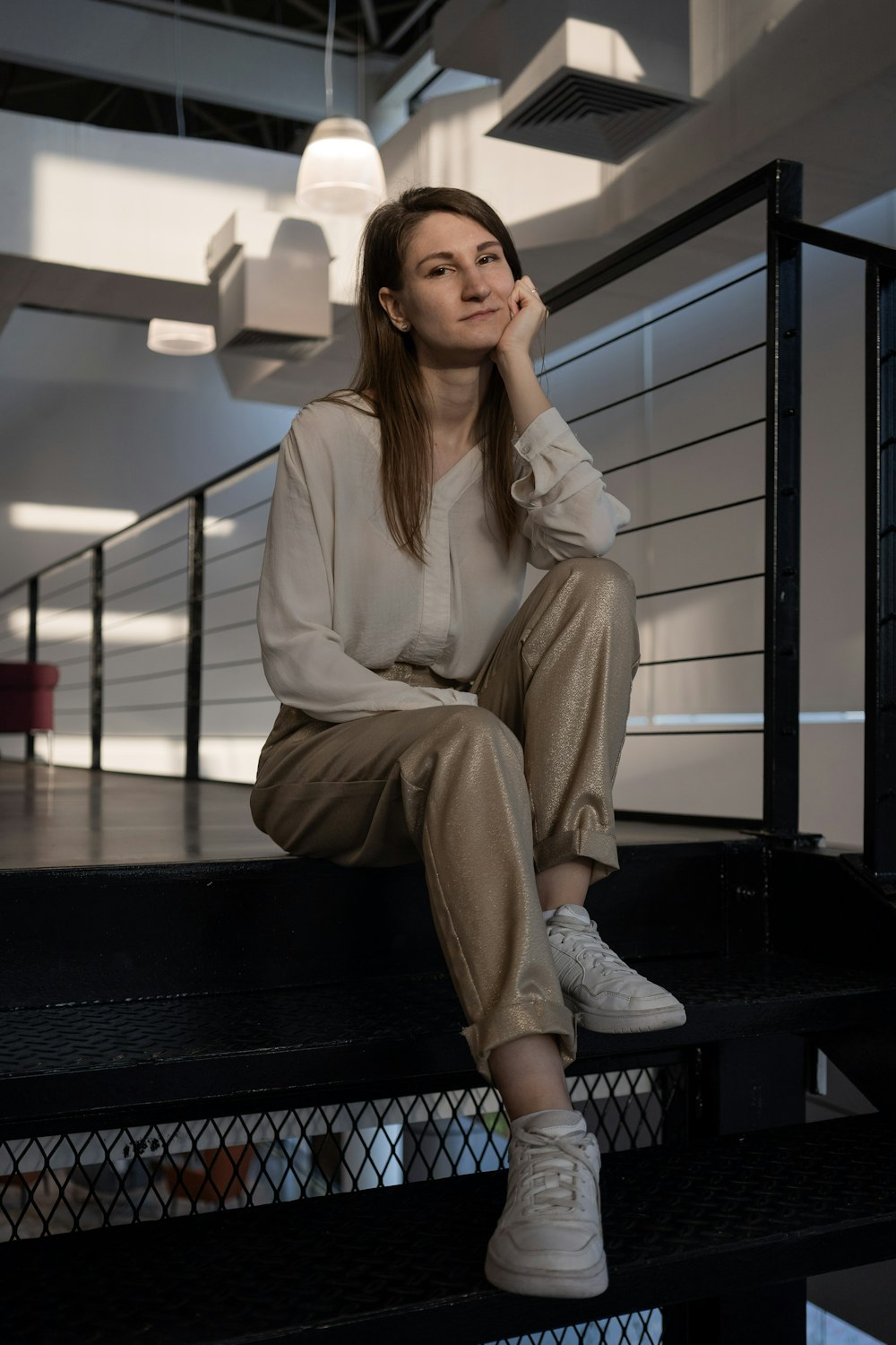 a woman sitting on the steps of a building