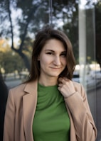 a woman standing in front of a glass wall