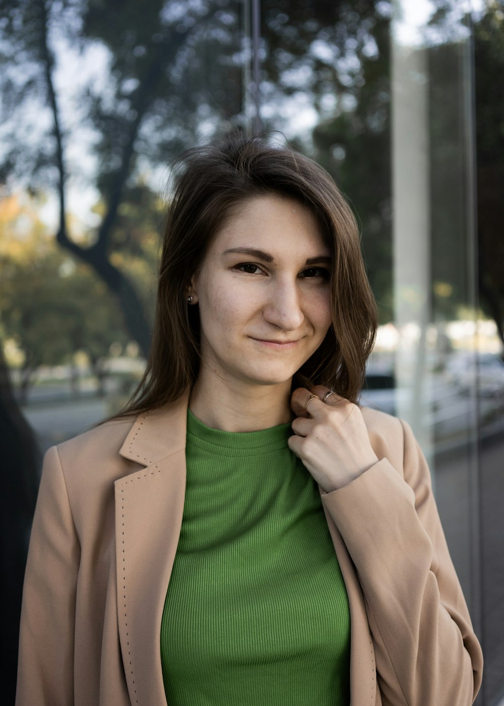 a woman standing in front of a glass wall