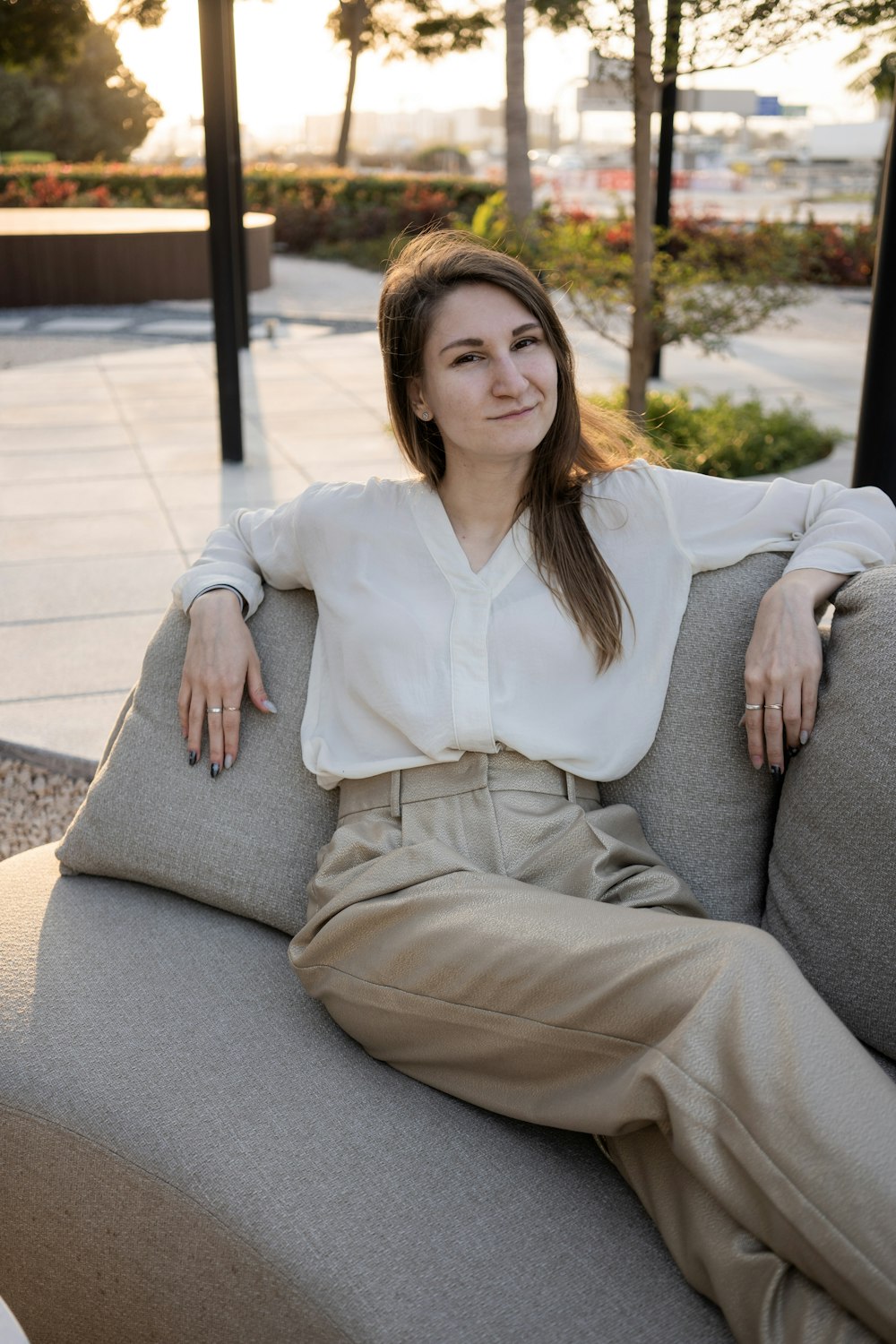 a woman sitting on top of a gray couch