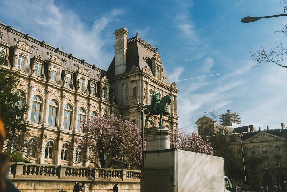 a large building with a statue in front of it