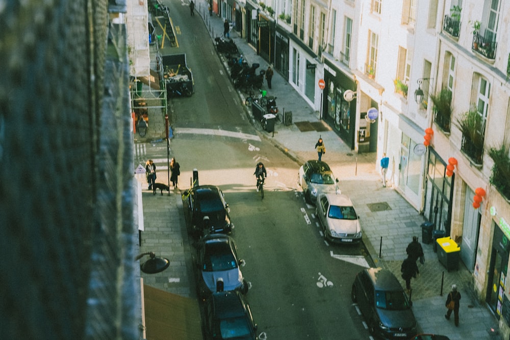 a city street filled with lots of traffic next to tall buildings