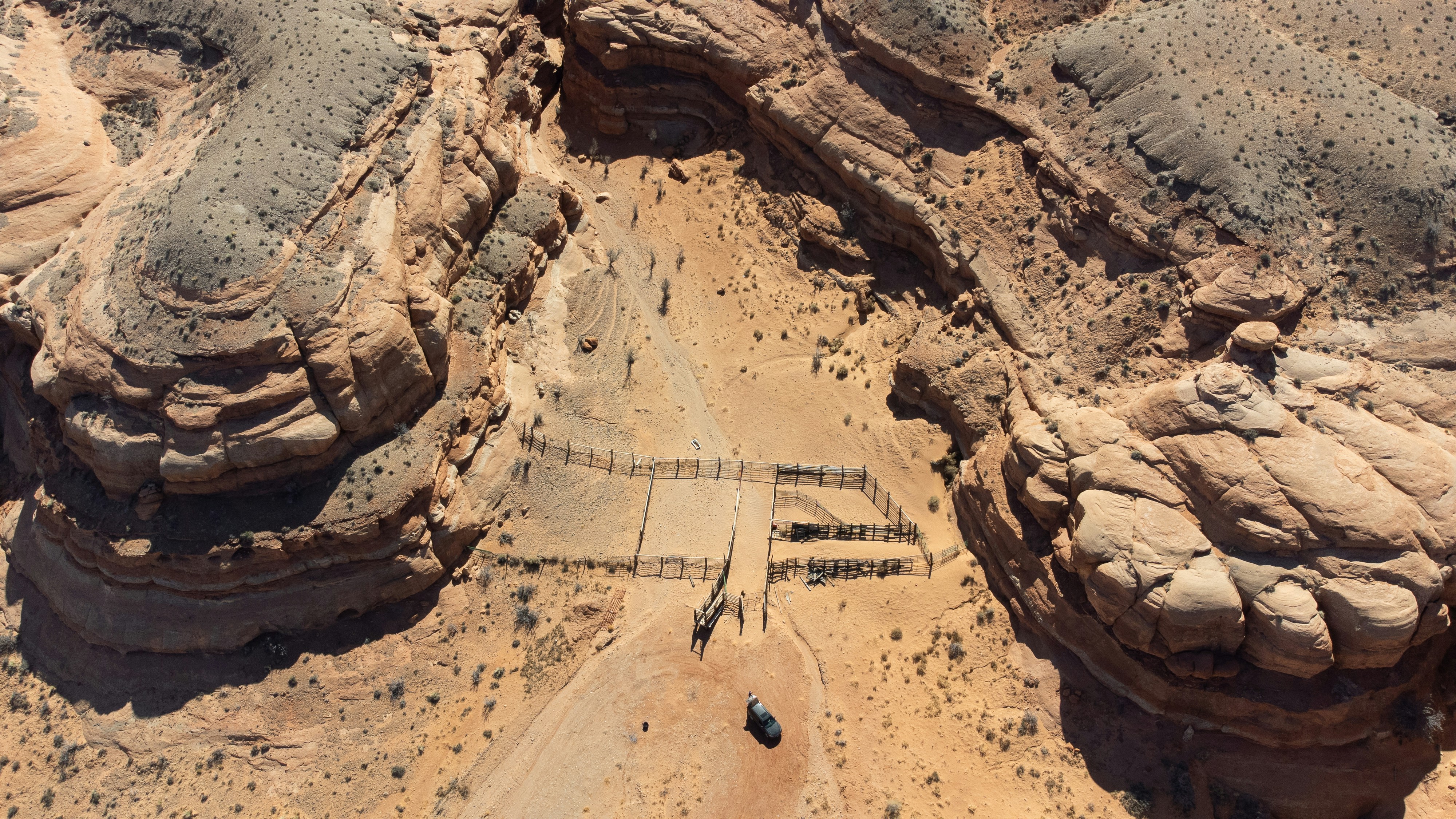An aerial view of a dirt road in the desert