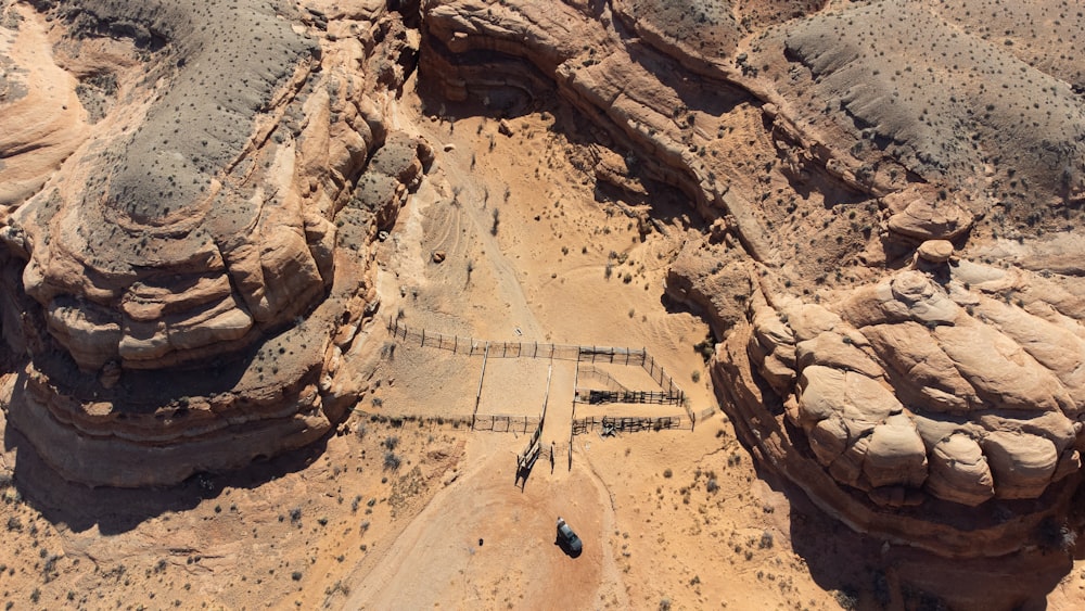 an aerial view of a dirt road in the desert