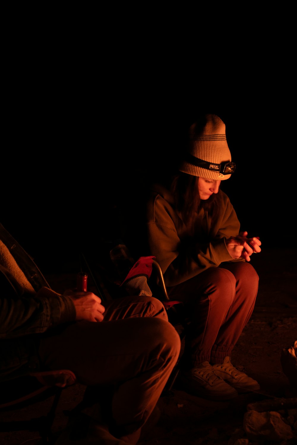a man sitting next to a woman in the dark