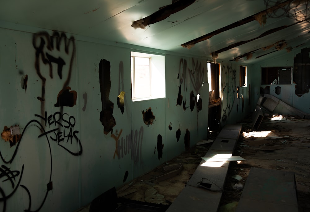 a run down room with graffiti on the walls