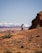 a person walking up a hill with mountains in the background