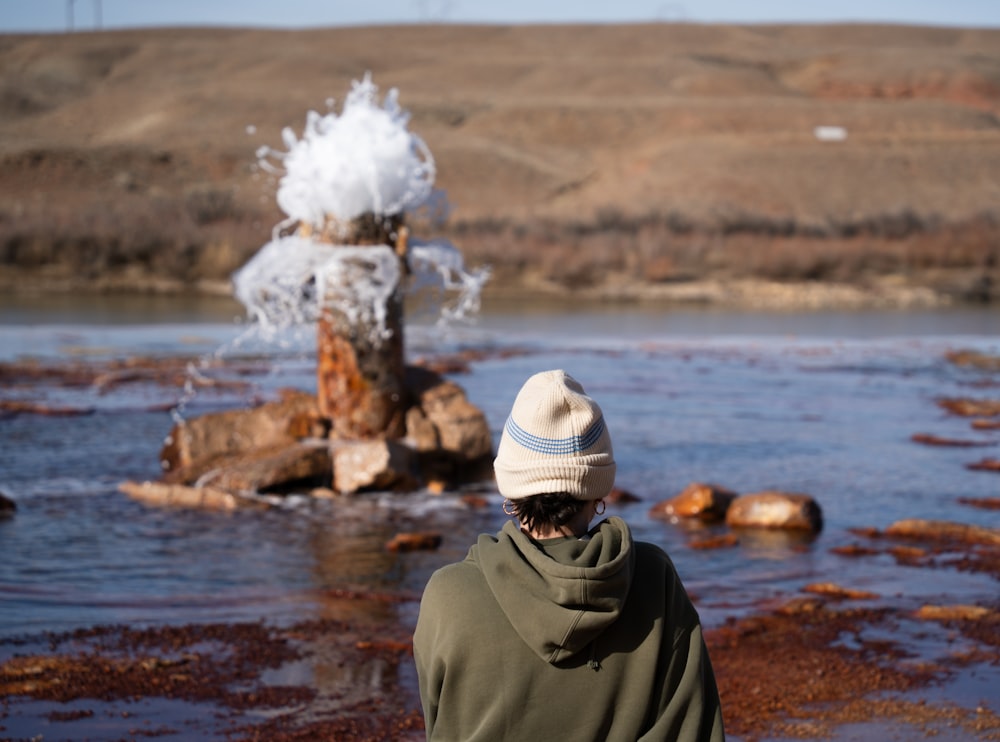 a person standing in front of a body of water