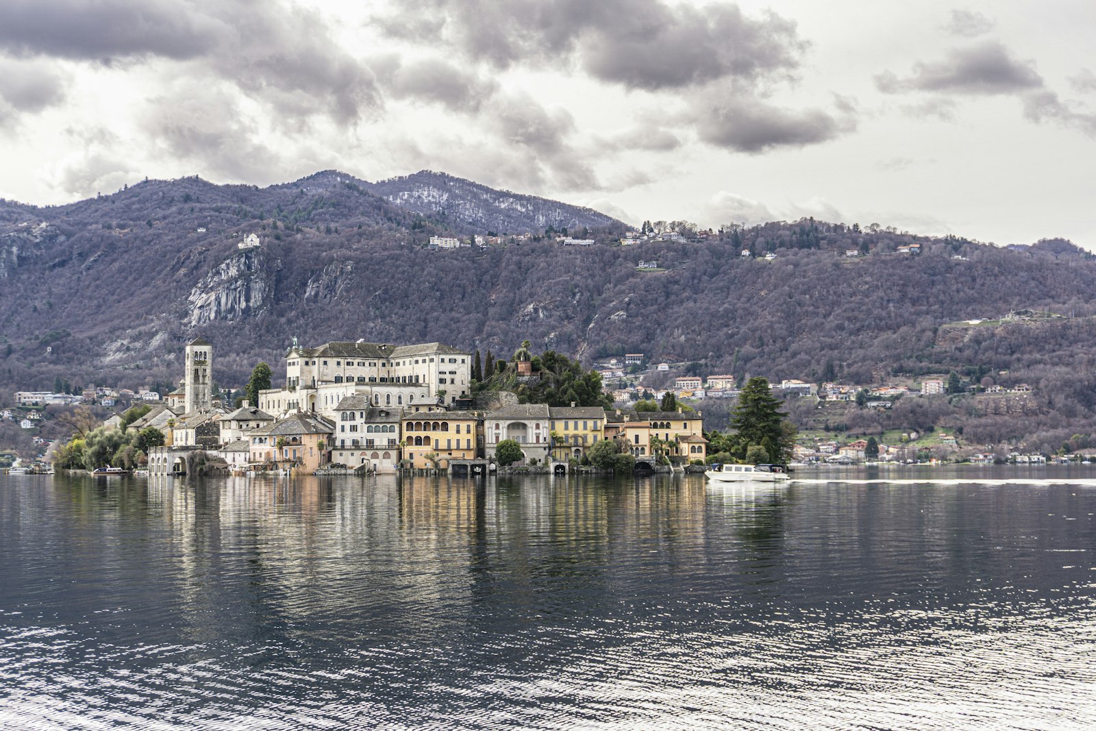 The island of San Giulio and its basilica bell tower in the middle of Lake Orta