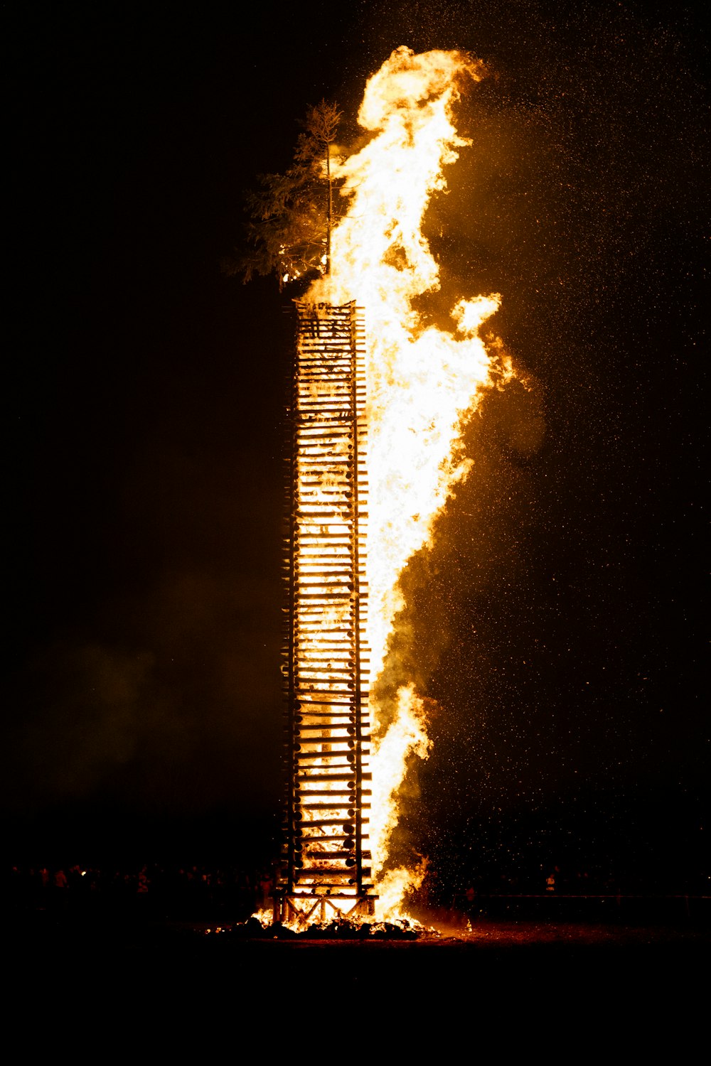 a tall tower that has a lot of fire coming out of it