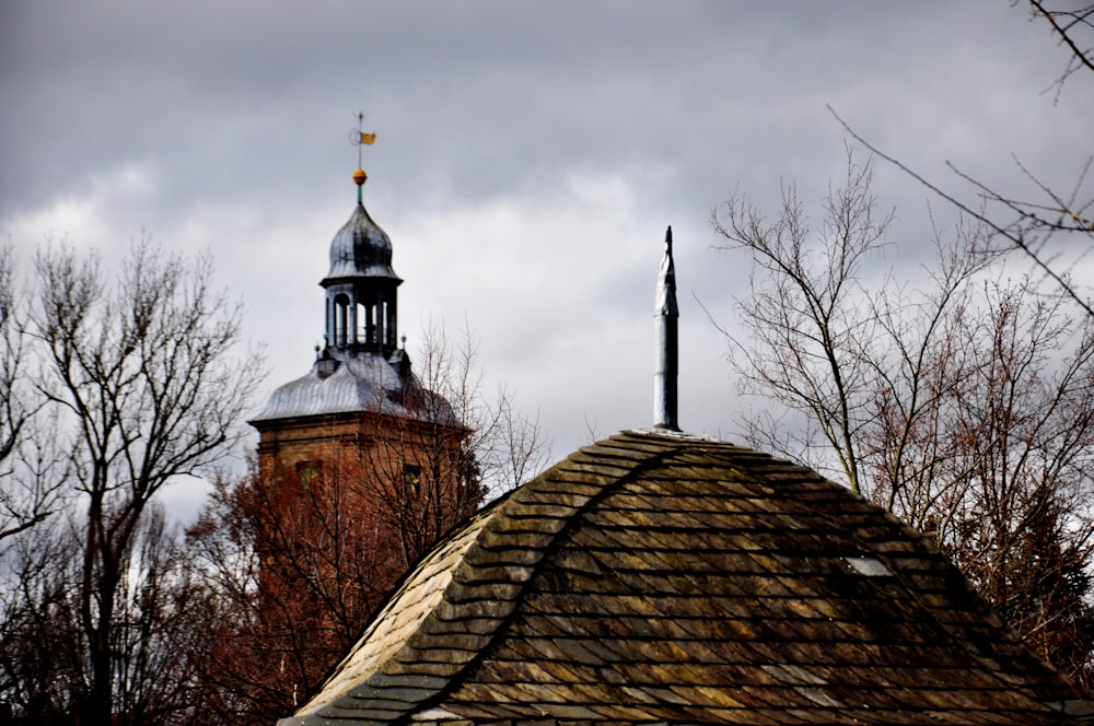 a church steeple with a weather vane on top
