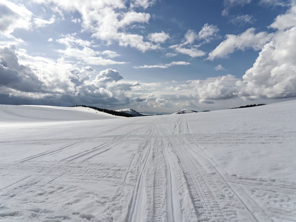 a person riding skis down a snow covered slope