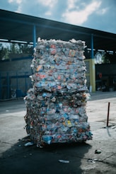 a large stack of garbage sitting in front of a building