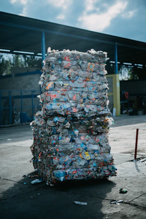 a large stack of garbage sitting in front of a building