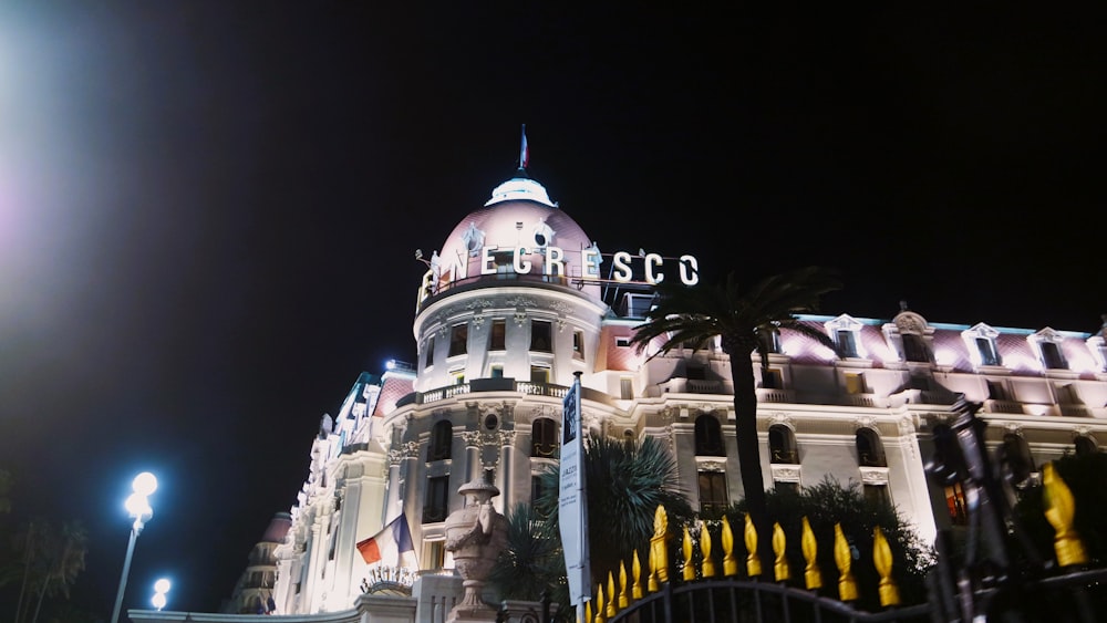 un grand bâtiment blanc illuminé la nuit