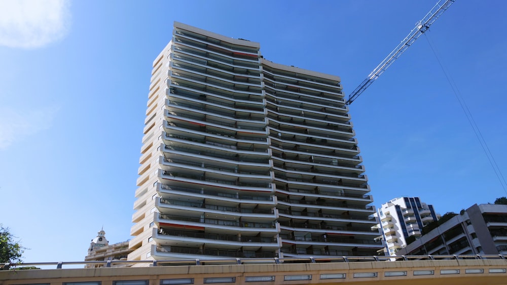 a tall building with a crane in the background