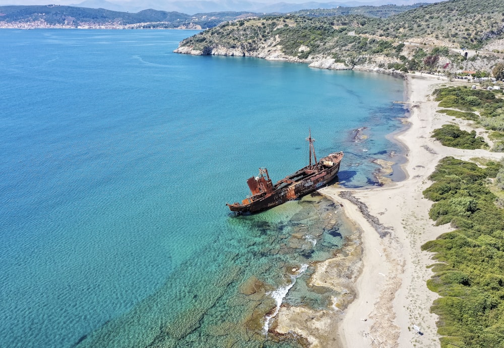 a large ship sitting on top of a sandy beach