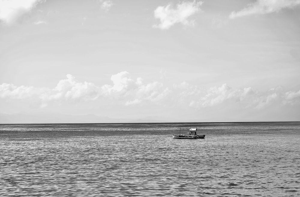 a small boat floating on top of a large body of water