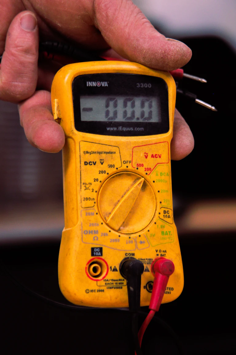 Electrician testing a circuit with a digital multimeter