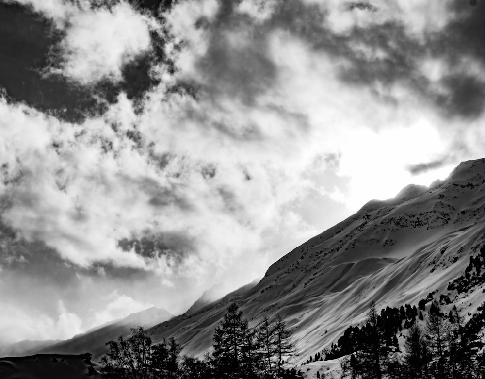 a black and white photo of a snow covered mountain