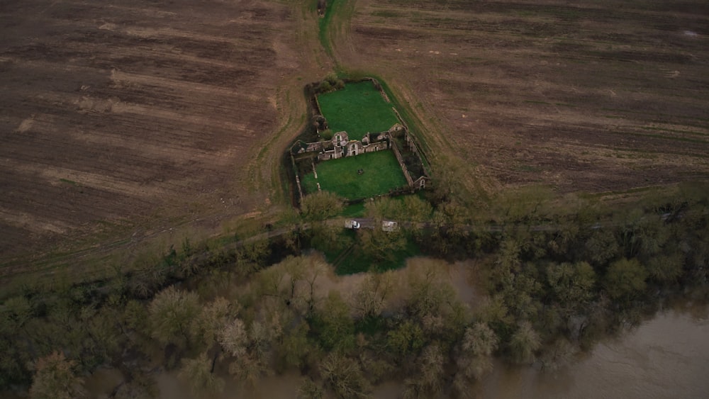 an aerial view of a house in the middle of a field