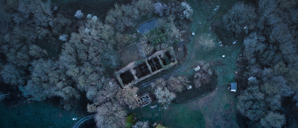 an aerial view of a house surrounded by trees