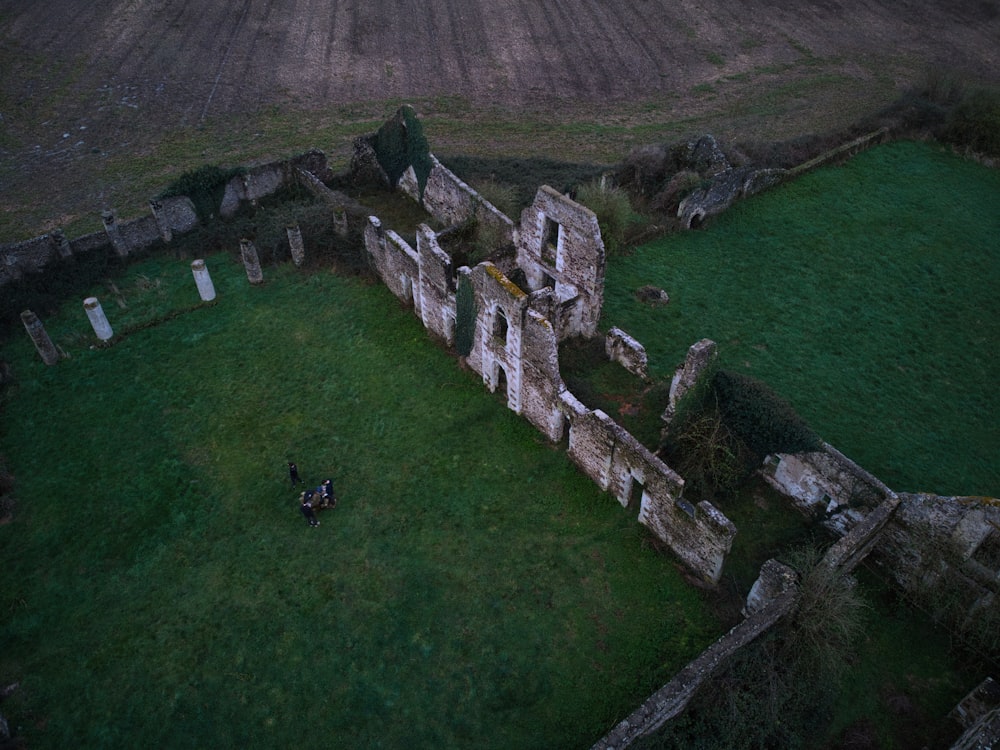 an aerial view of an old building in the middle of a field