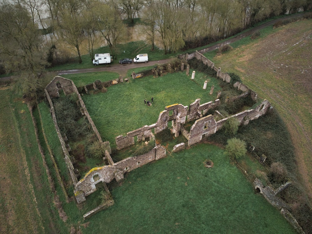 an aerial view of a castle with a green field