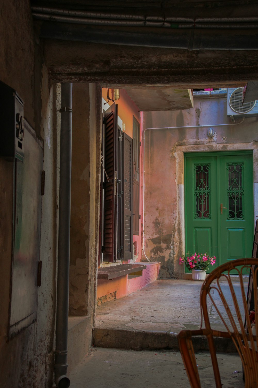 a green door and a chair in a room