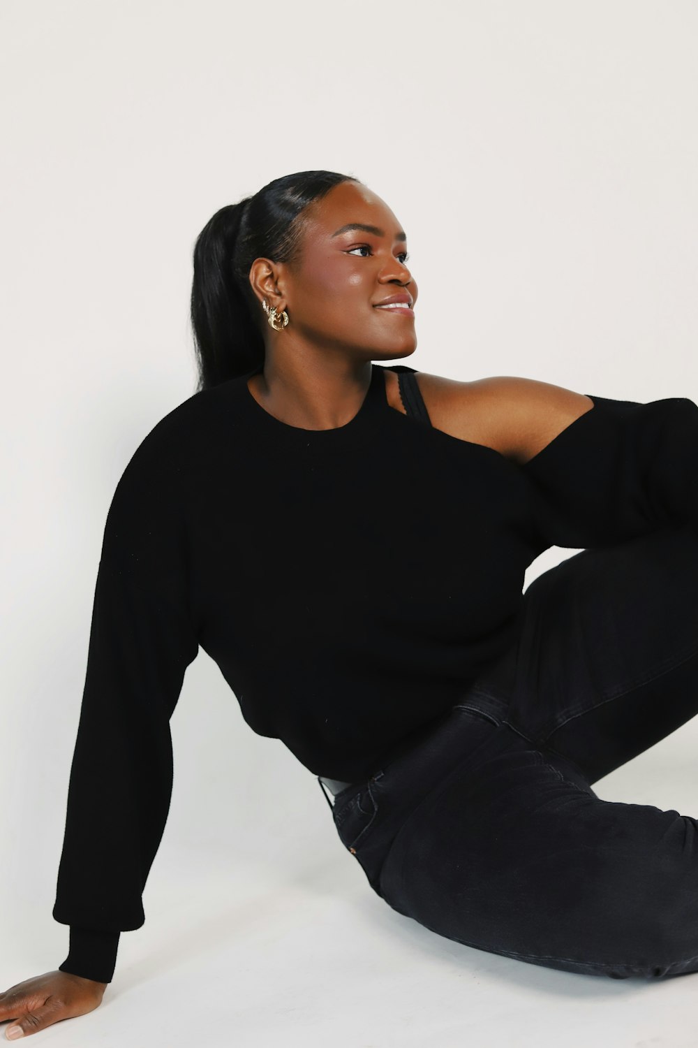 a woman sitting on the ground with her legs crossed