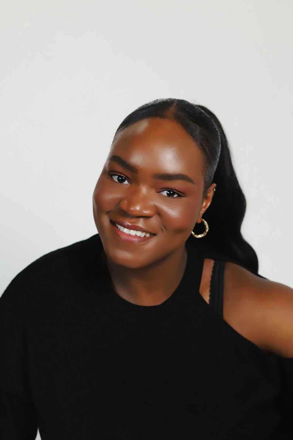 a woman in a black top smiling at the camera