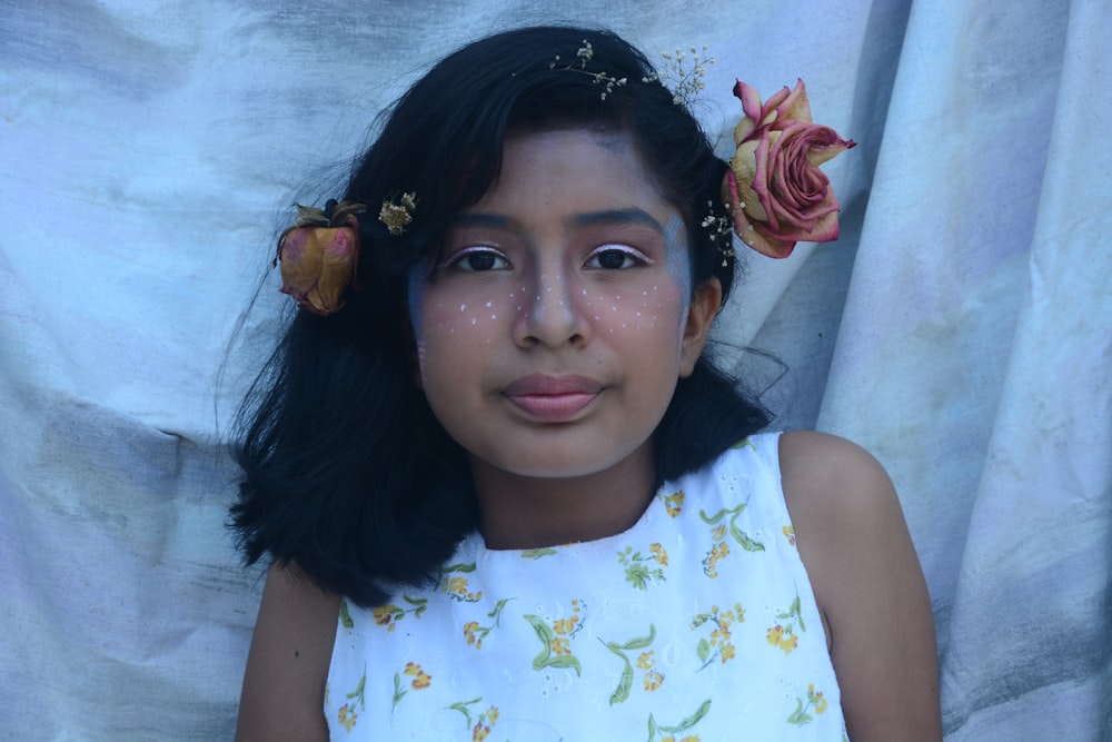 a young girl with a flower in her hair