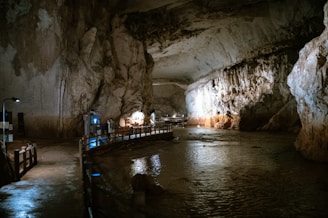 a group of people standing inside of a cave