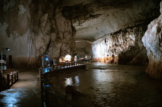a group of people standing inside of a cave