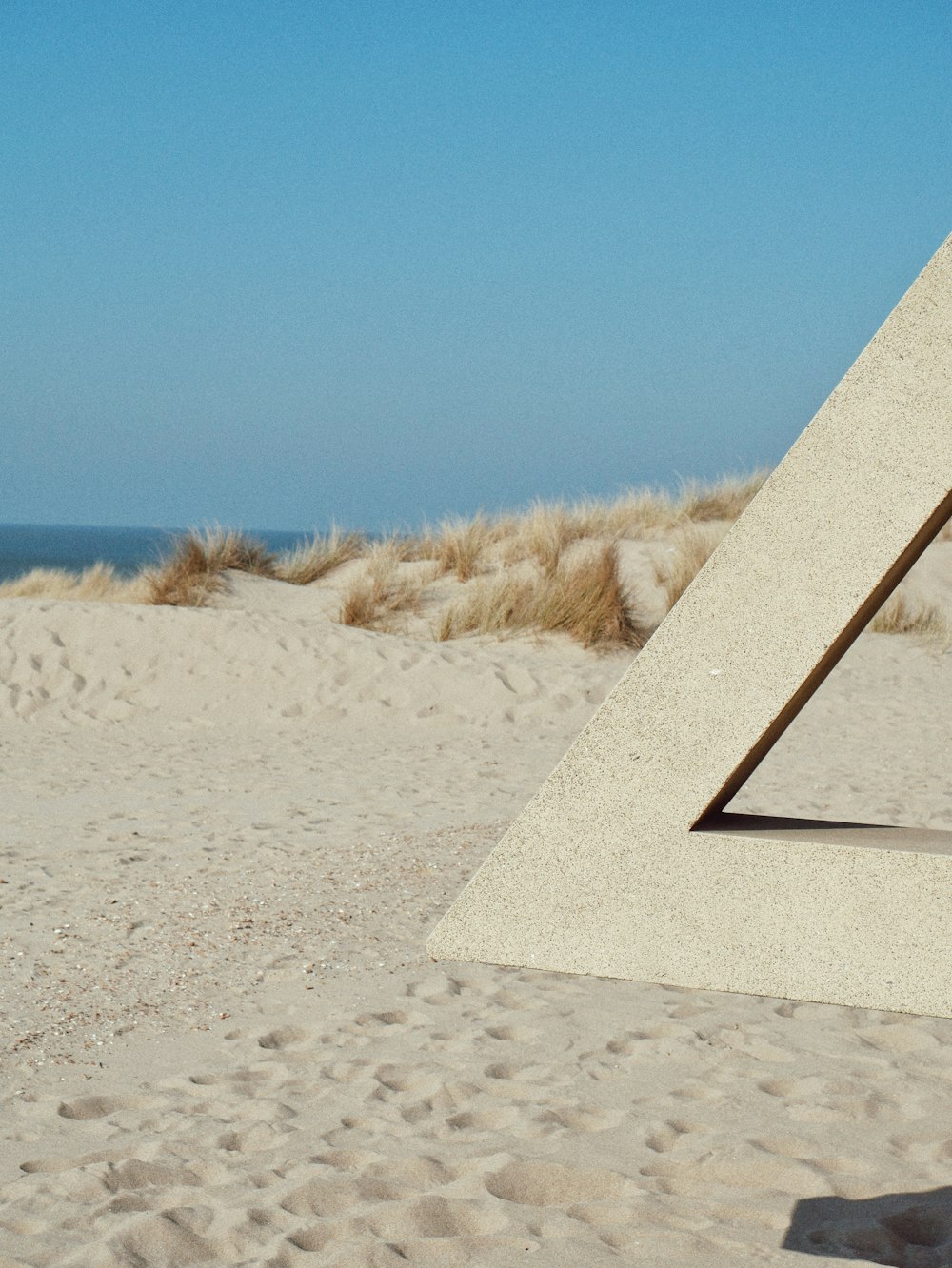 a sculpture in the sand on a beach