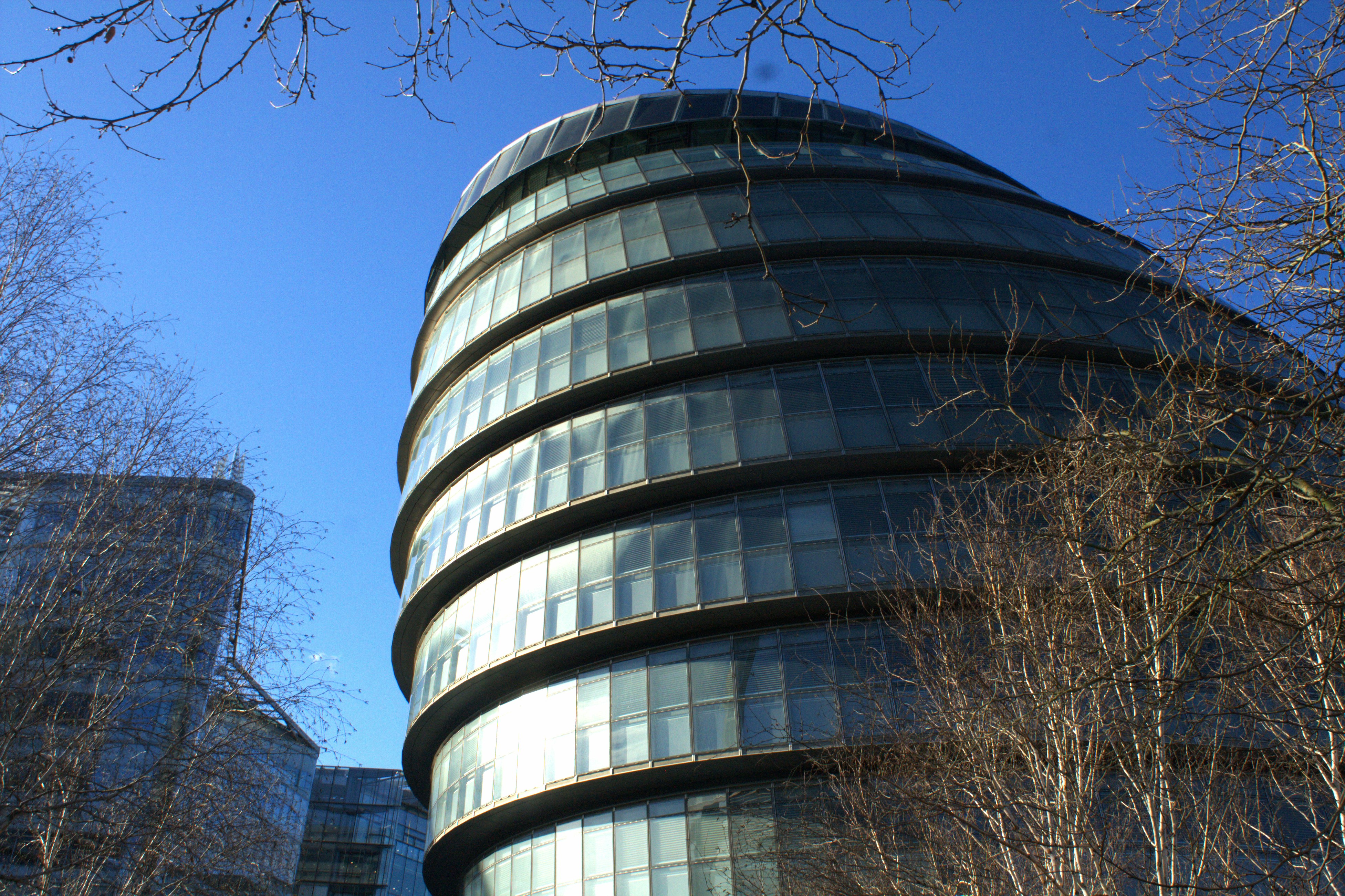 a very tall building with a curved glass front