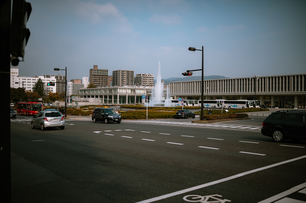 a city street filled with lots of traffic next to tall buildings