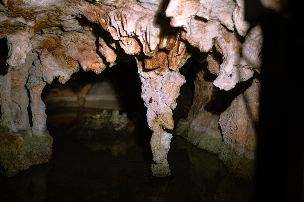 a cave filled with lots of rocks and water
