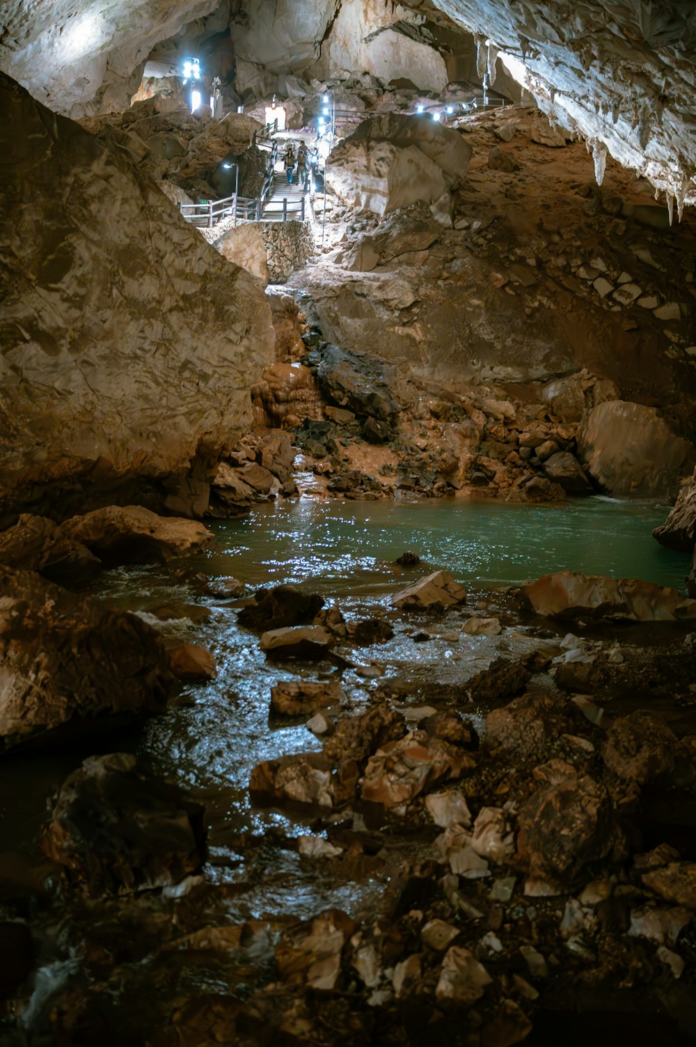 a small stream running through a cave filled with rocks