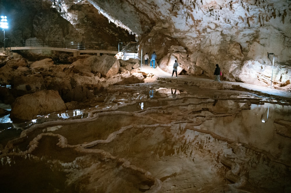 a group of people standing inside of a cave