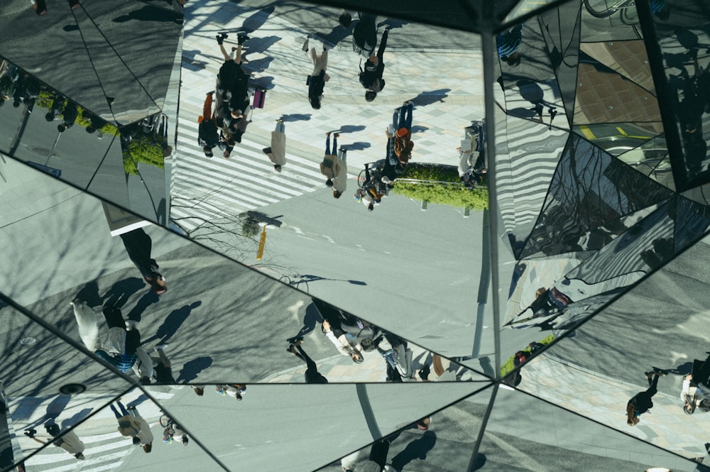 a group of people walking down a street next to a cross walk