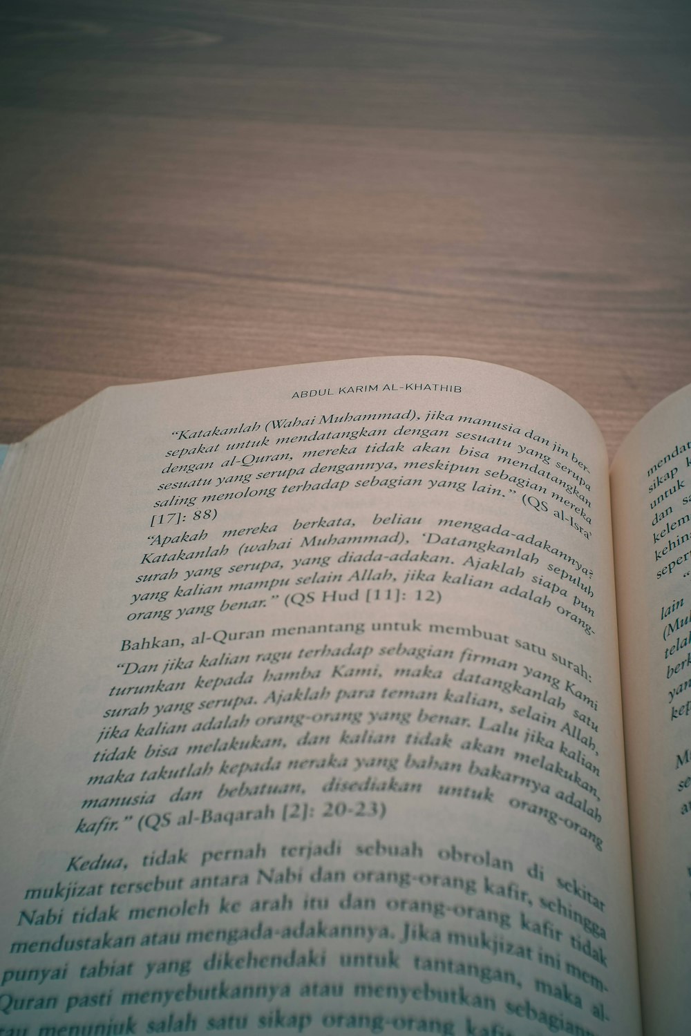 an open book sitting on top of a wooden table