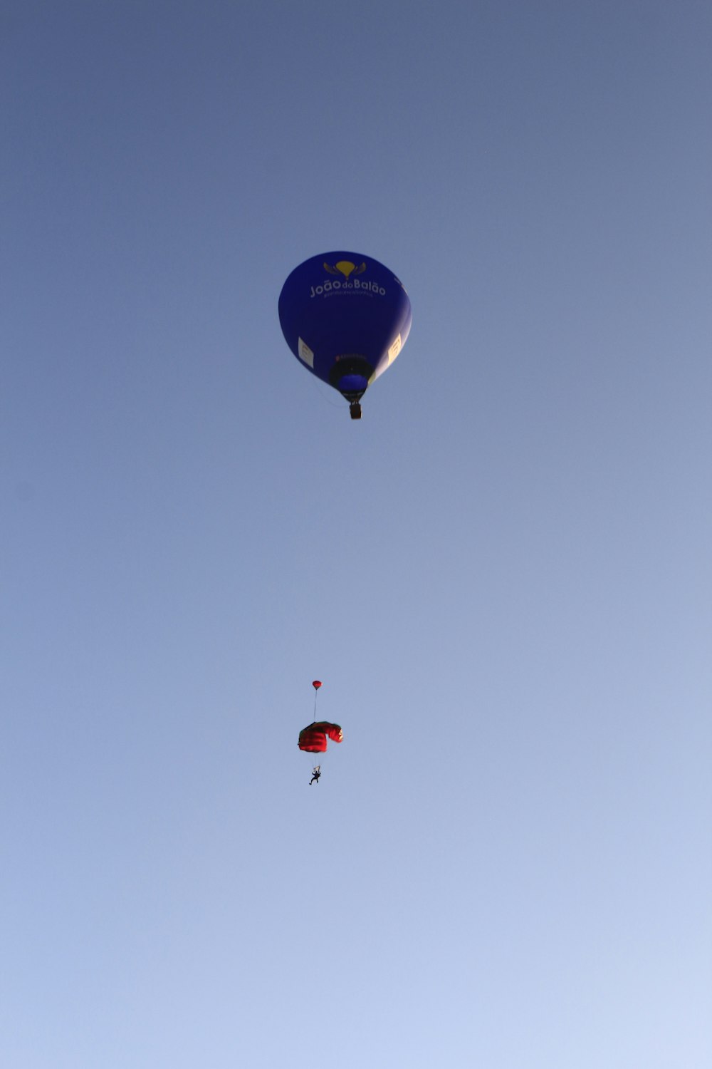 a group of people flying kites in the sky