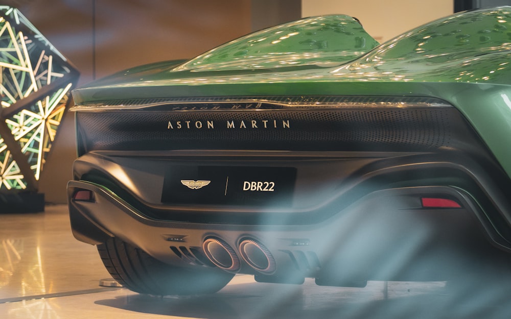 a close up of the rear end of a green sports car