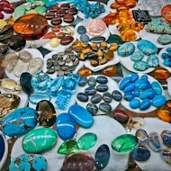 a table topped with lots of different colored rocks