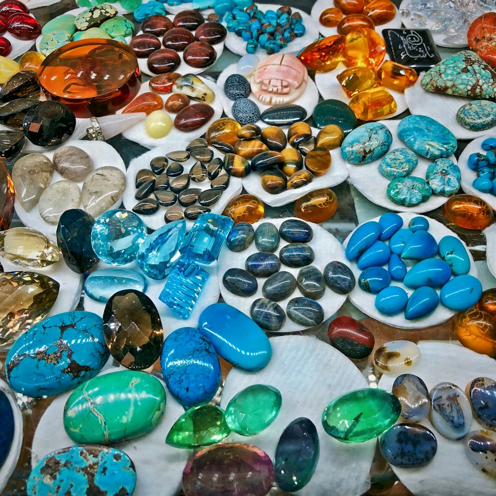 a table topped with lots of different colored rocks
