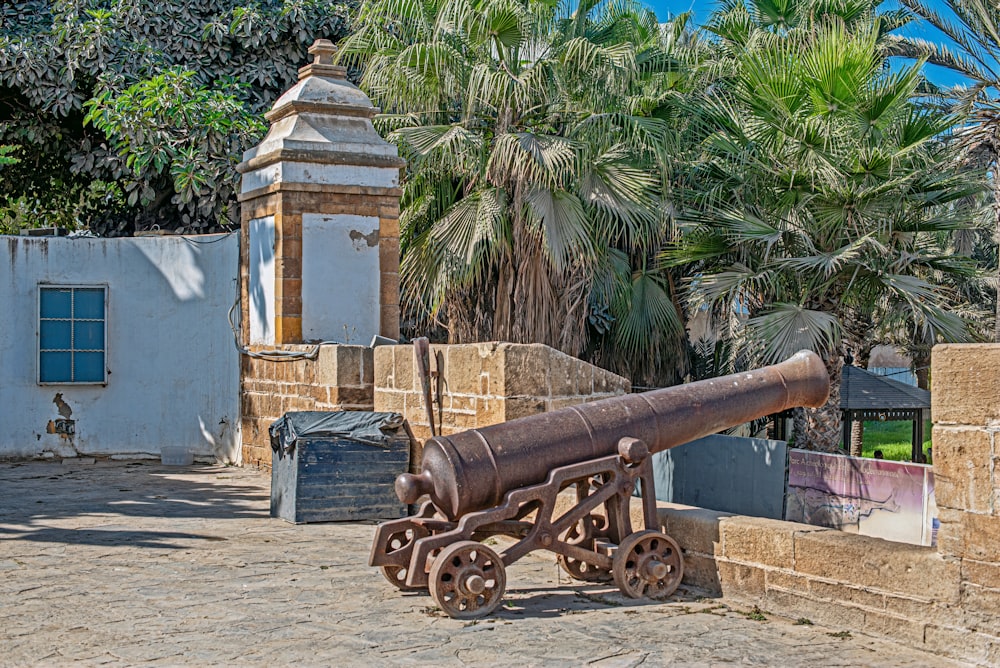 an old cannon sitting on top of a stone wall