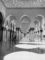 a black and white photo of a building with arches