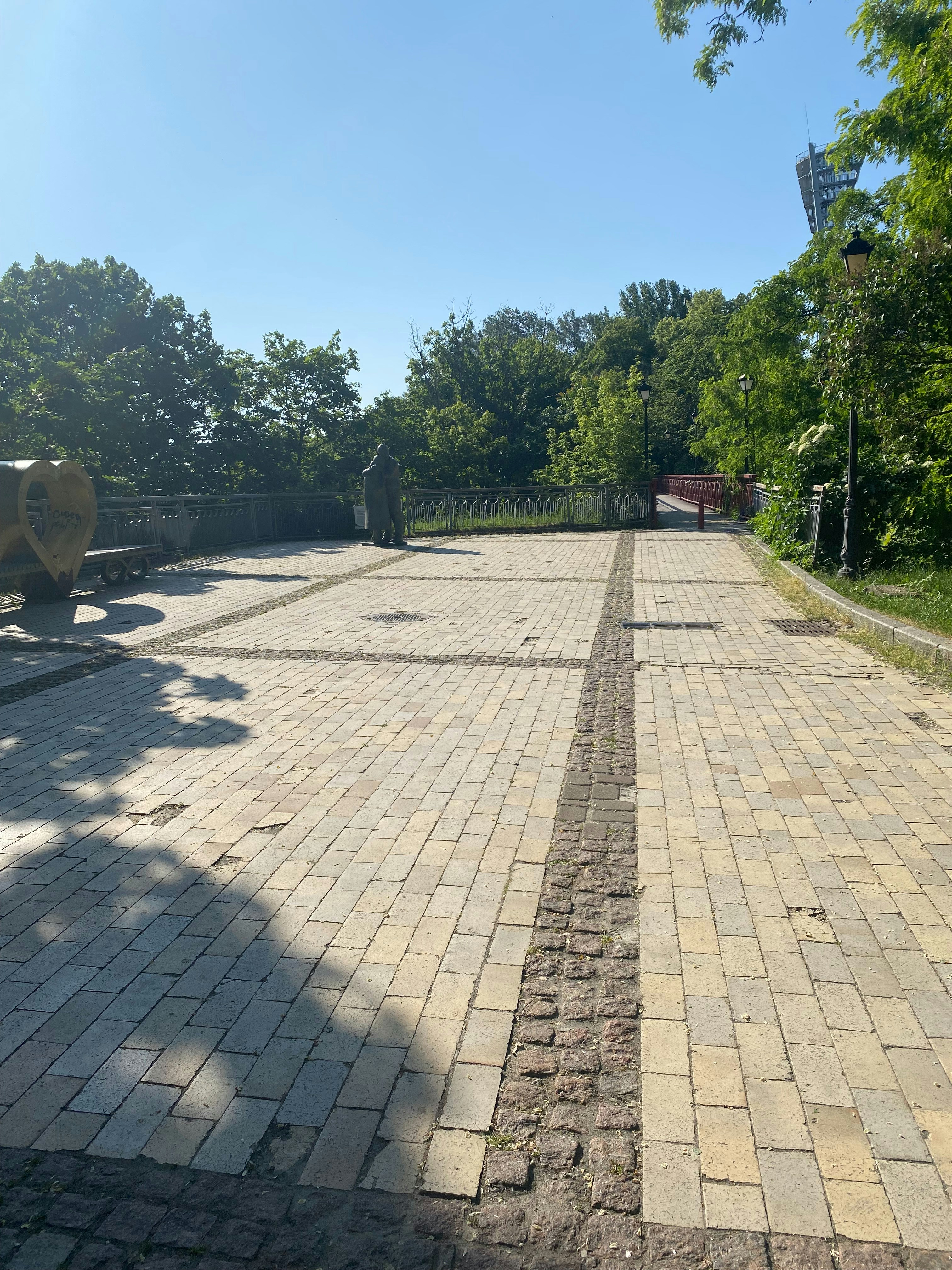 a brick road with a fire hydrant in the distance